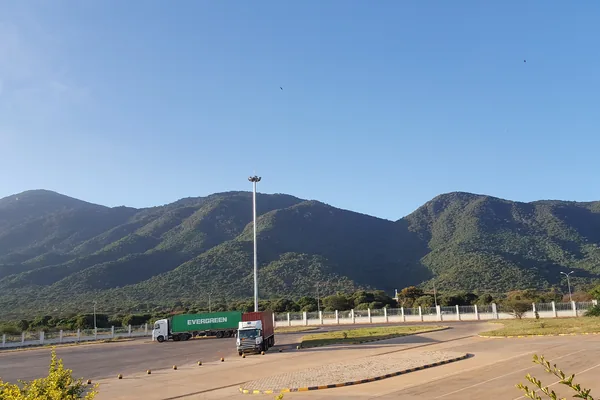 A truck on the road at Namanga with hills behind.